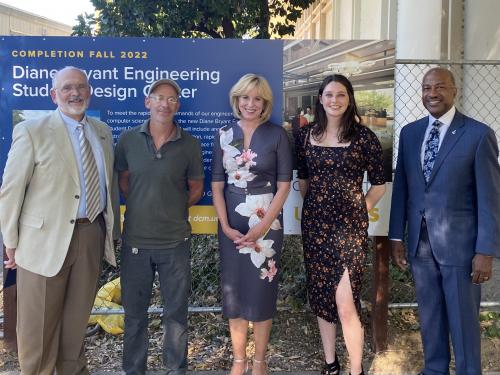 Diane Bryant, Chancellor May, College of Engineering Interim Dean Gibeling, Kurt Kornbluth pose for photo in front of the new Diane Bryant Engineering Student Design Center sign